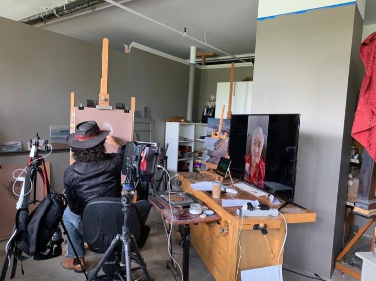 Photograph of artist Alexey Steele in his studio drawing subject Janet Hoult in live stream session October 2020