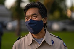 Photograph of Rich Yamashita wearing uniform and face mask