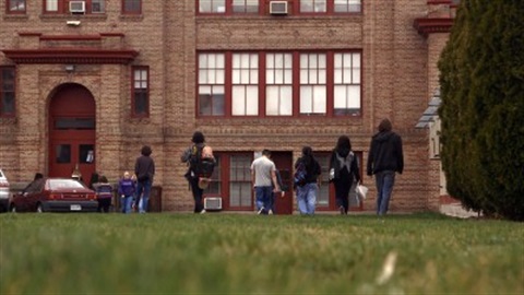 Lincoln High School exterior with kids walking in