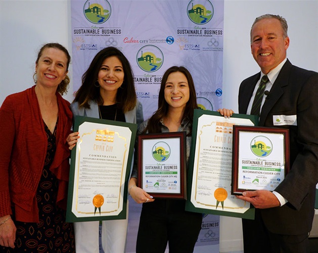 Council Member Alex Fisch presenting Sustainable Certificate to Reformation