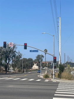 2021 photograph of intersection of Higuera St and Jefferson Blvd, showing signal light, street lanes, and Higuera St bridge