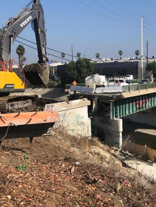 2021 Photograph of demolition of Higuera Street Bridge, showing construction equipment working to remove a segment of bridge