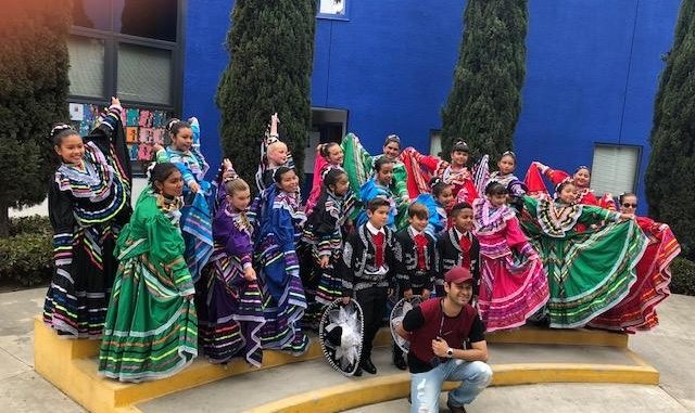 Folklorico dancers standing in a group