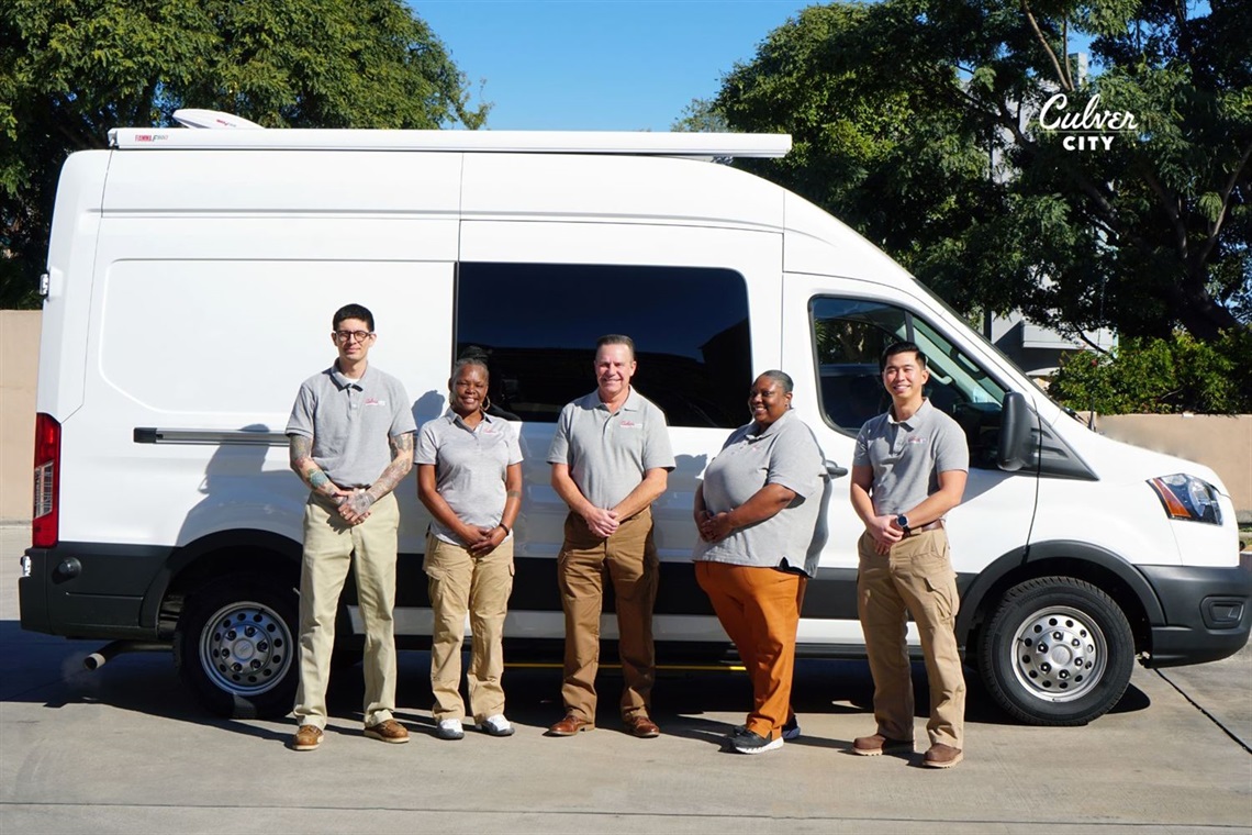 Mobile Crisis Team posing in front of the van they will use to assist people in need