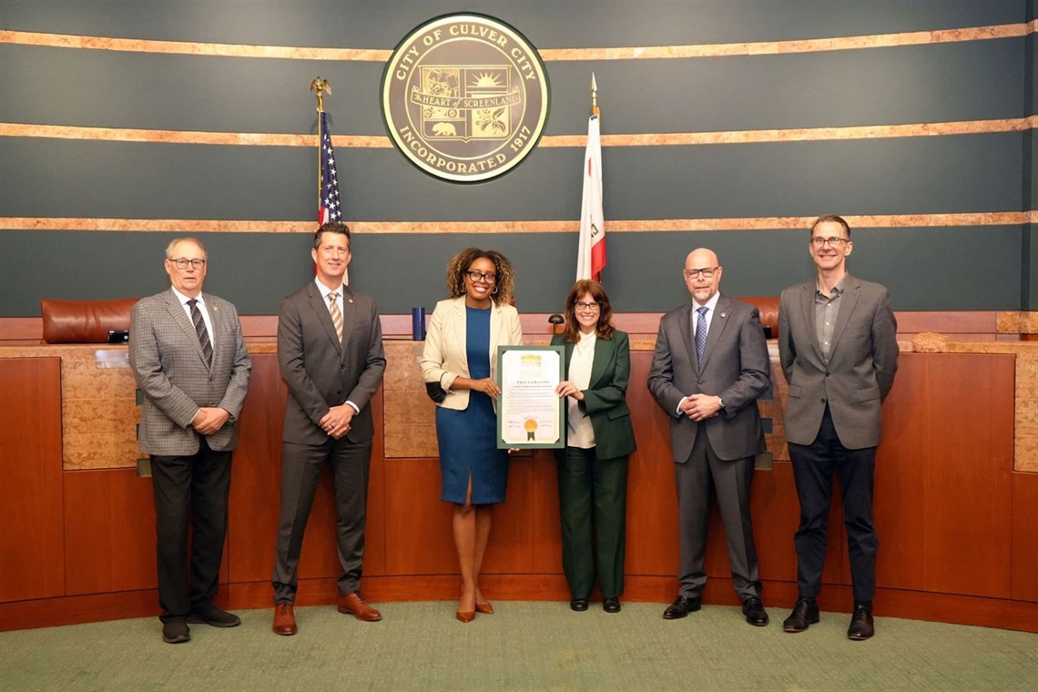 Photo of City Council with City Clerk posing for photo with proclamation
