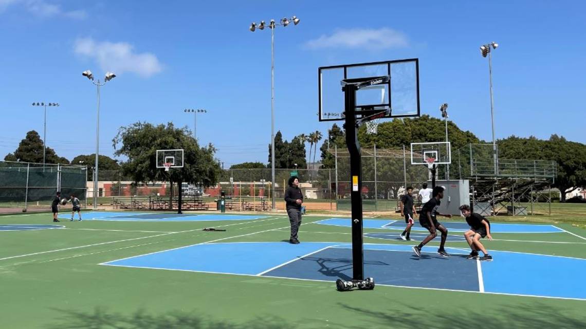 Group of Young Men Playing Basketball at Vets Park