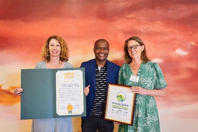 Photograph of Mayor Daniel Lee and representatives from Village Well Books and Coffee receiving Sustainable Business Certificate at event June 2022